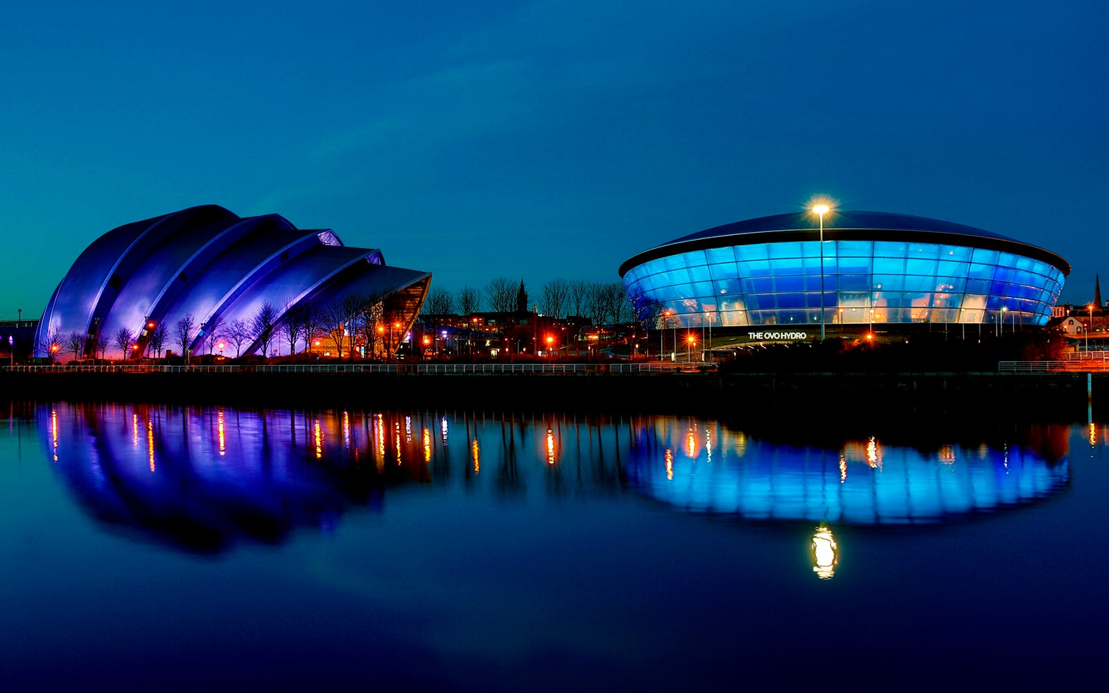View of the SEC Armadillo and OVO Hydro from the River Clyde at night.
