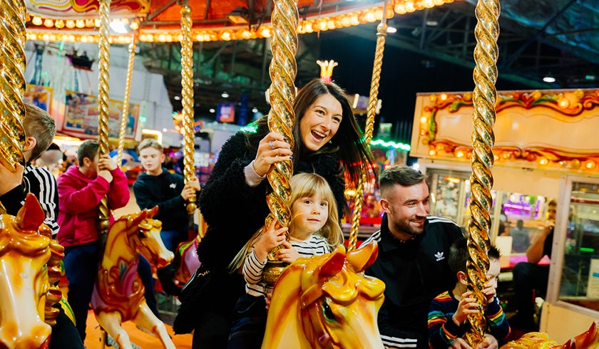 Family on a carousel ride at the Irn-Bru Carnival.