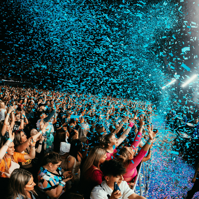 Clubland concert with blue confetti falling on audience