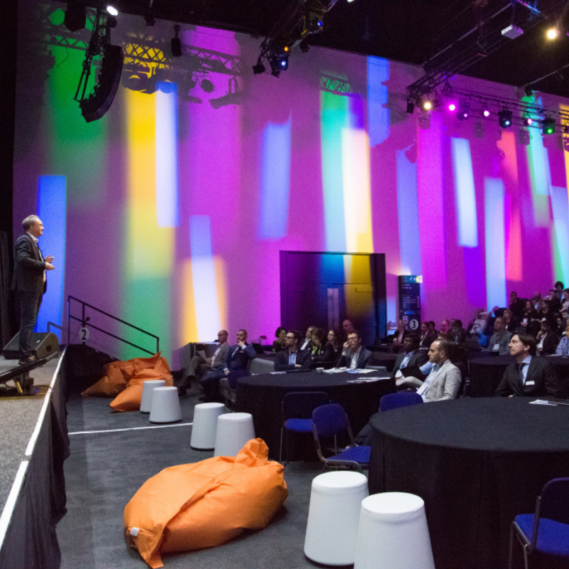 lomond auditorium set up in cabaret seating with colourful lighting