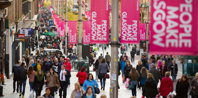 View of Buchanan Street Glasgow that features the general public and &quot;People Make Glasgow&quot; flags.