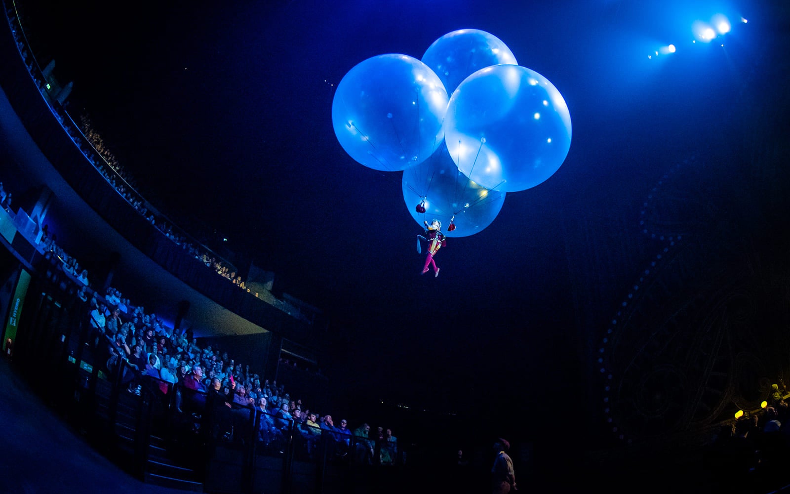 woman floating in air with balloons in Cirque Du Soleil