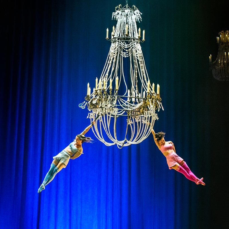 two woman hanging from giant chandelier at Cirque Du Soleil