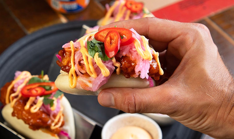 Hand holding taco in Clydebuilt restaurant.
