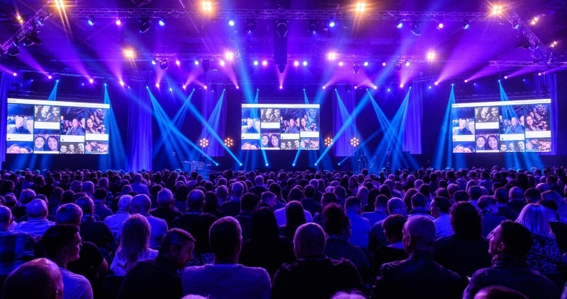 View of the stage and the audience with at a conference at the Scottish Event Campus. 