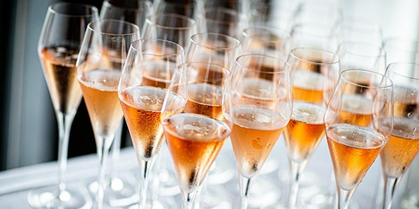 Close up of numerous glasses of champagne.