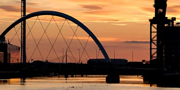 View of the millennium bridge over the River Clyde at dusk.