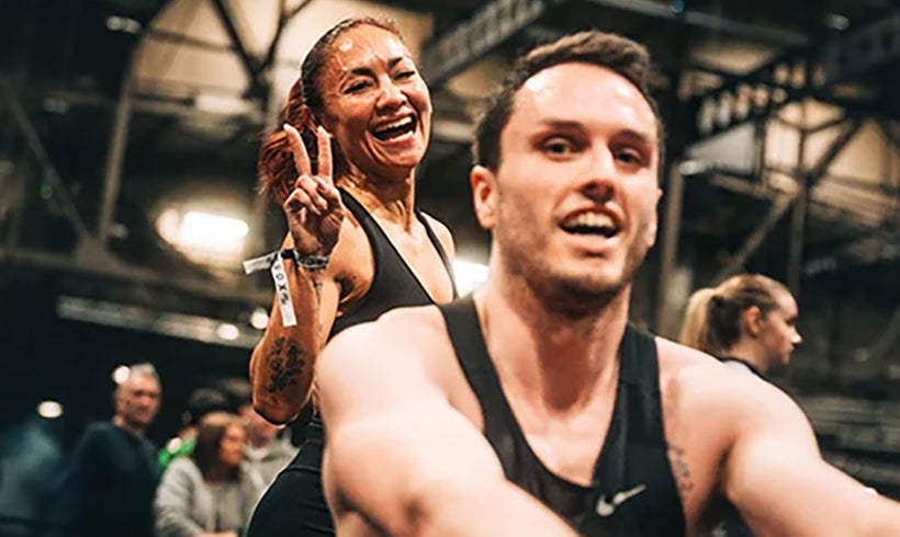 Man and women posing whilst completing Hyrox.