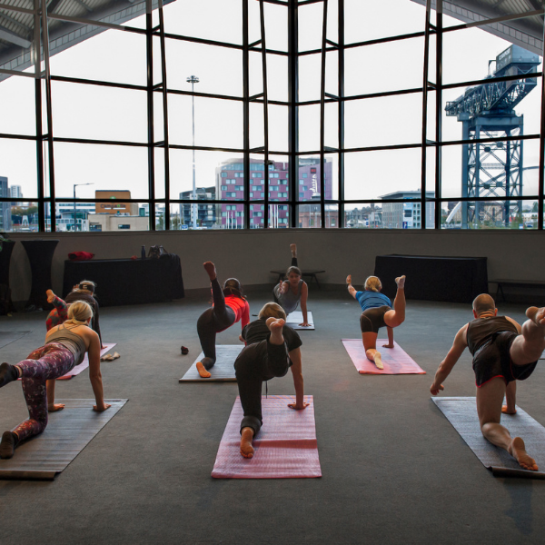 Delegates doing yoga inside the SEC Armadillo.