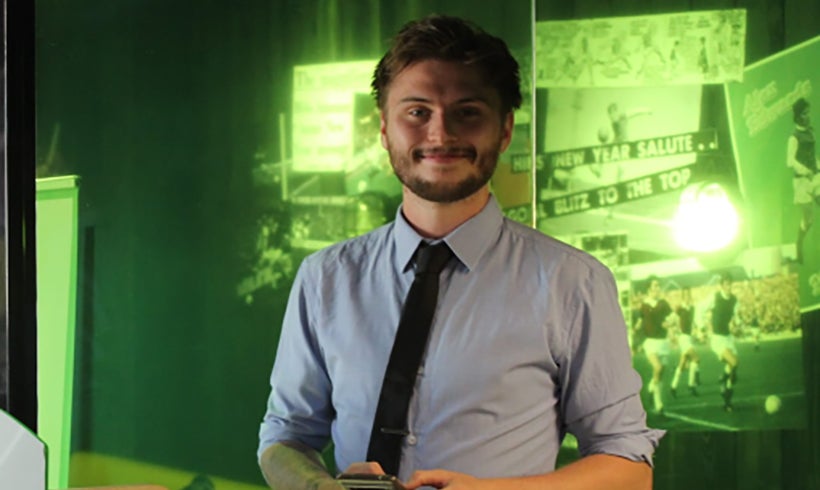 Jordan Gorman standing in front of screen projections.