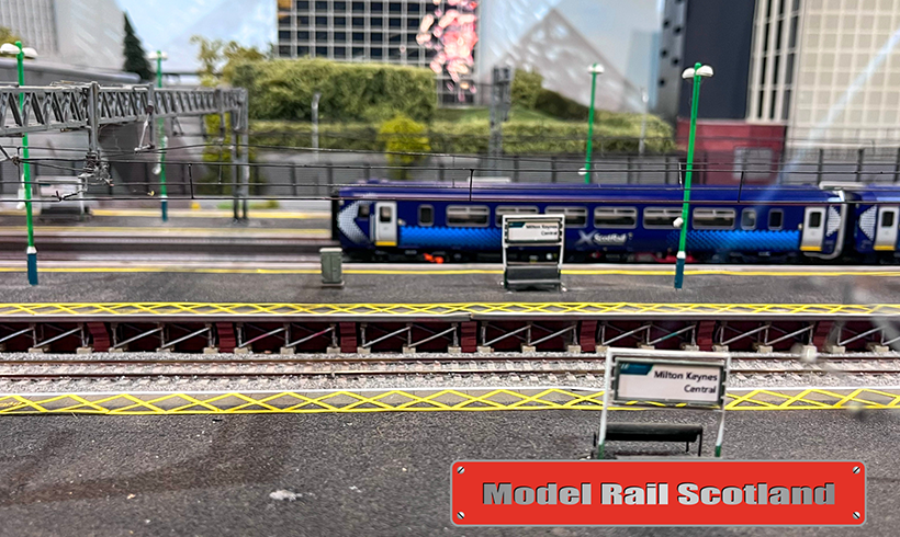Model Rail train set build of a Scotrail train at a train station.