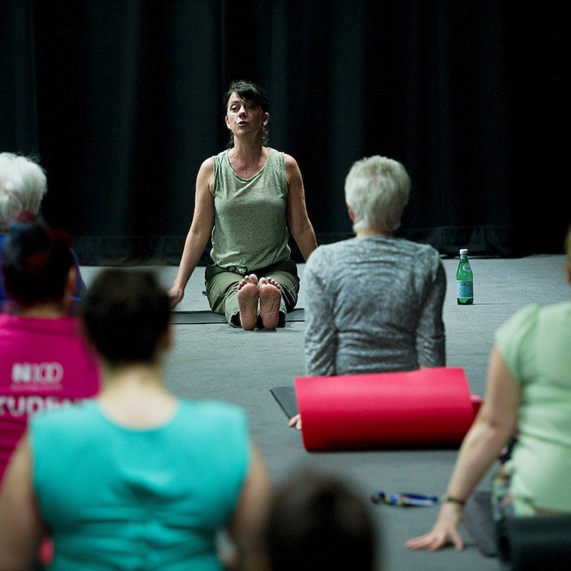 A group of people doing yoga.