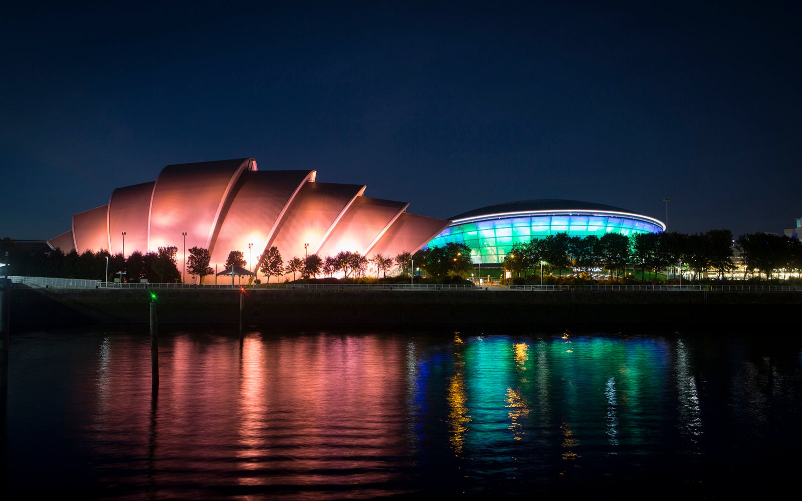 View of the SEC Armadillo and OVO Hydro from the River Clyde at night time.
