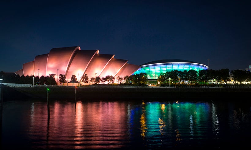 View of the SEC Armadillo and OVO Hydro from the River Clyde at night time.