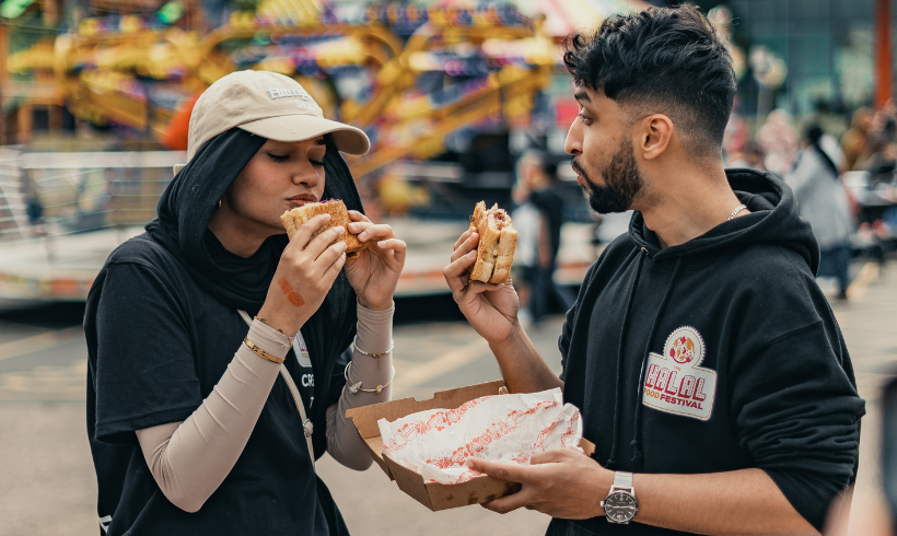 Two people sharing food.