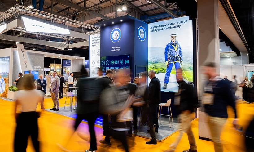 People walking through a trade exhibition.