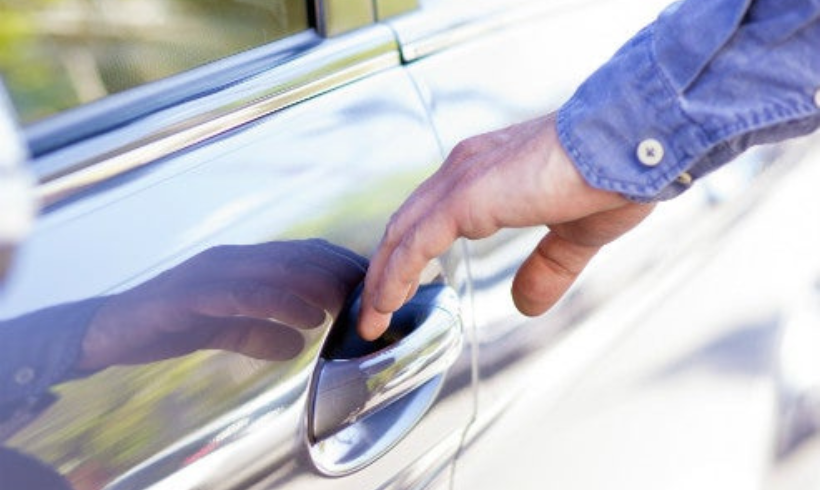 Man's hand opening car door