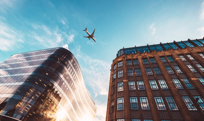 Plane flying over Glasgow City Centre on a sunny day from below