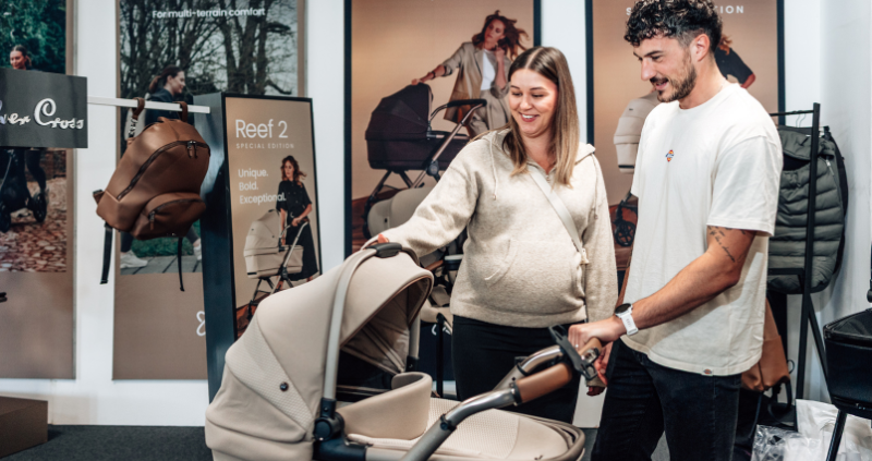 A couple shopping for a pram.