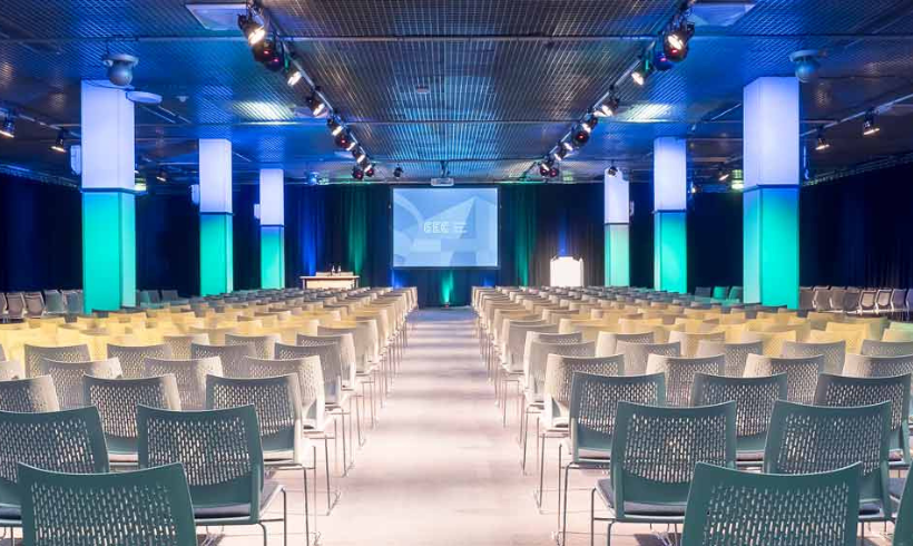 Image of SEC Hall 5 with chairs laid out facing a projection screen at the front