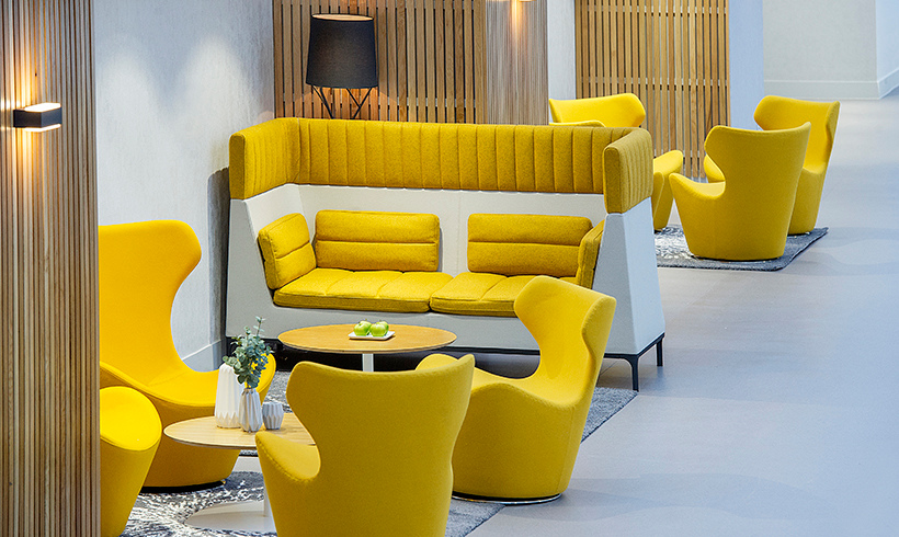 Image of a yellow couch and chairs in the SEC Meeting Academy