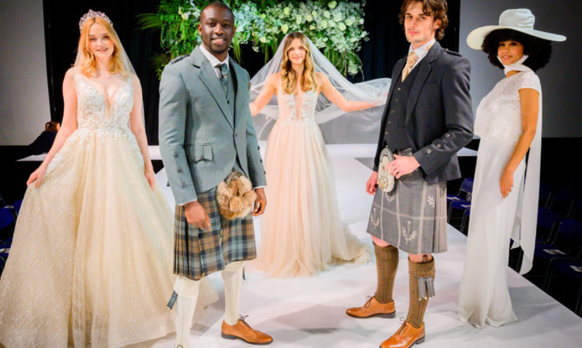 Models on a catwalk wearing wedding dresses and kilts. 